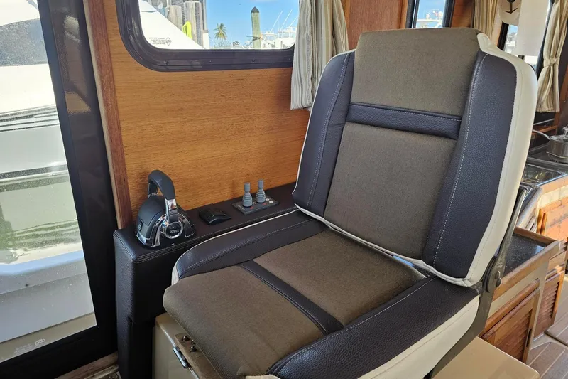  Yacht Photos Pics Captain's chair in 2014 Ranger Tugs R 31 boat interior, featuring control panel and window view.