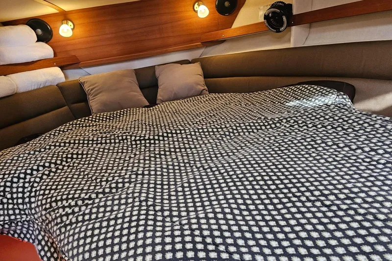  Yacht Photos Pics Cozy cabin interior of 2014 Ranger Tugs R 31 with patterned bedding and ambient lighting.