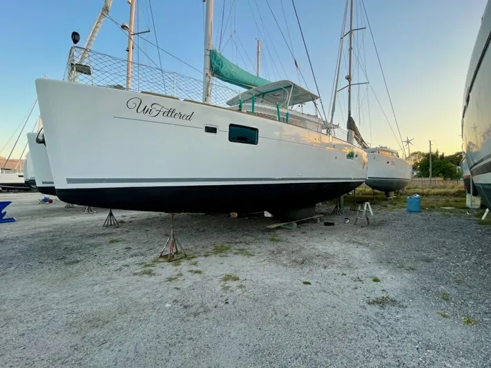 Unfettered Yacht Photos Pics 2015 Lagoon 450 F catamaran on land, sunset background.