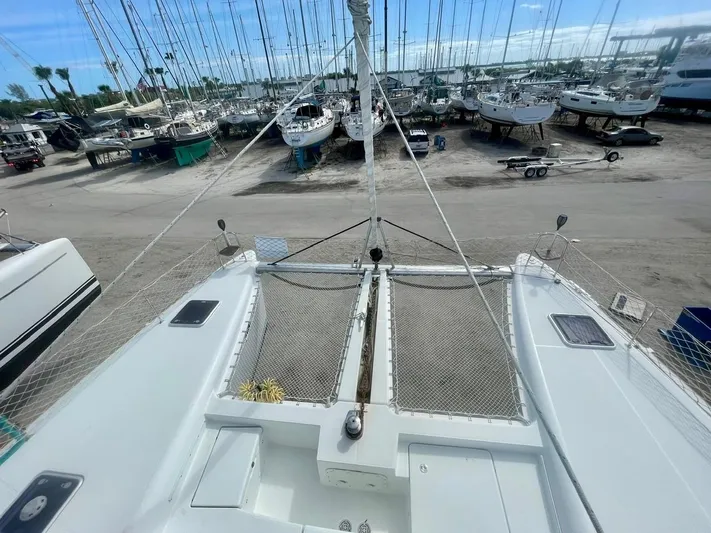 Unfettered Yacht Photos Pics 2015 Lagoon 450 F catamaran on dry dock, surrounded by other boats.