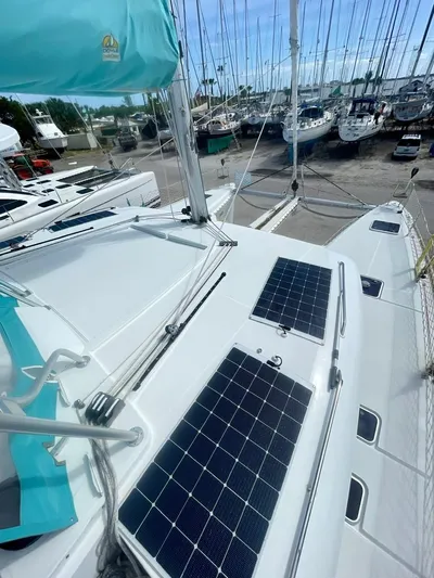 Unfettered Yacht Photos Pics 2015 Lagoon 450 F catamaran with solar panels in a marina.