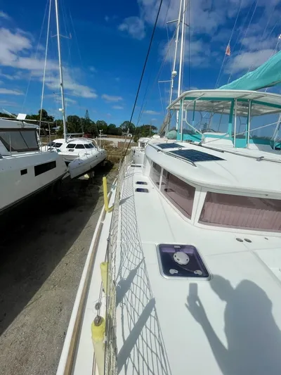 Unfettered Yacht Photos Pics 2015 Lagoon 450 F catamaran docked under clear blue sky.