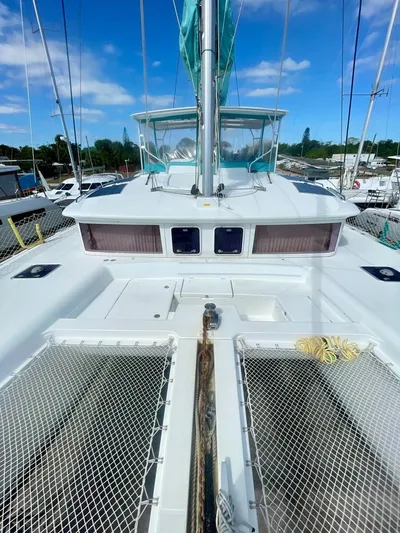 Unfettered Yacht Photos Pics 2015 Lagoon 450 F catamaran deck with netting and clear blue sky.