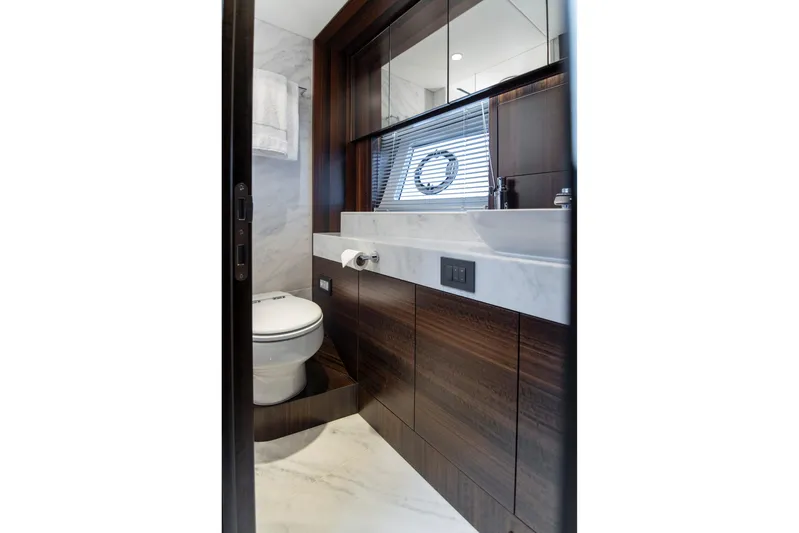 Baillies Yacht Photos Pics Luxurious bathroom in 2021 Sunseeker Manhattan 68 yacht with modern fixtures and elegant design.
