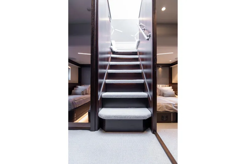 Baillies Yacht Photos Pics Interior staircase of 2021 Sunseeker Manhattan 68 yacht, leading to luxurious bedrooms.