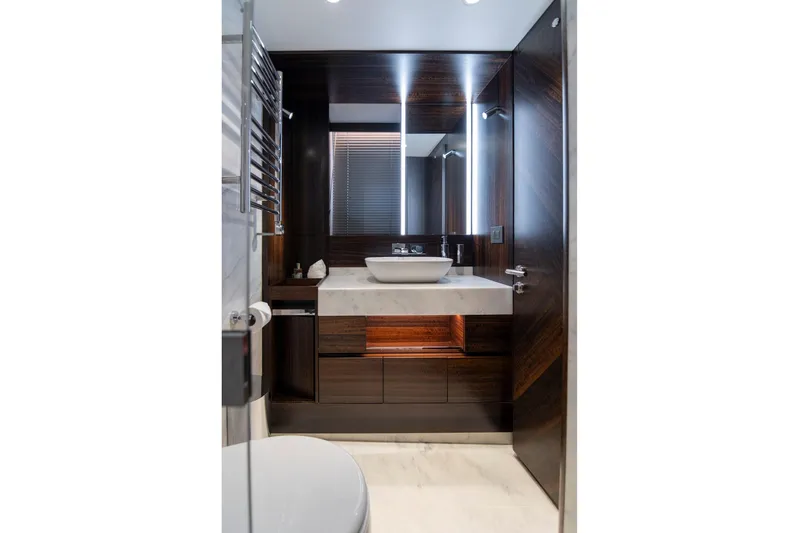Baillies Yacht Photos Pics Luxurious bathroom in 2021 Sunseeker Manhattan 68 yacht with modern fixtures and elegant design.