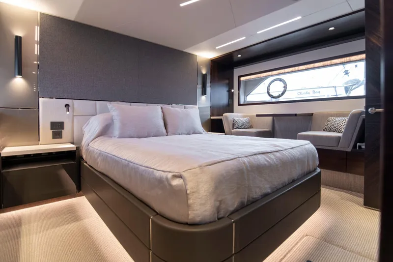 Baillies Yacht Photos Pics Luxurious bedroom interior of 2021 Sunseeker Manhattan 68 yacht, featuring modern design and elegant furnishings.