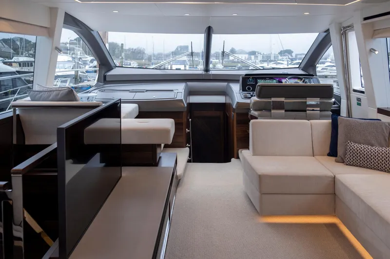 Baillies Yacht Photos Pics Luxurious interior of 2021 Sunseeker Manhattan 68 yacht with modern seating and helm.