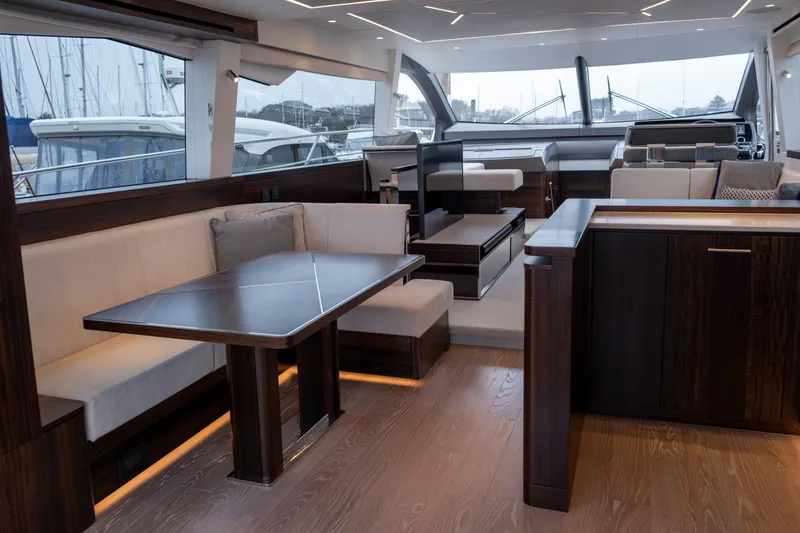 Baillies Yacht Photos Pics Luxurious interior of 2021 Sunseeker Manhattan 68 yacht with elegant seating and modern design.