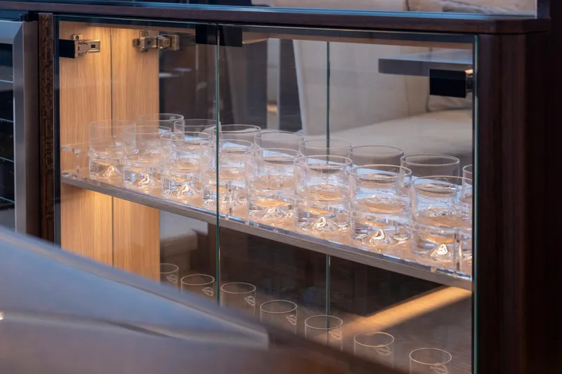 Baillies Yacht Photos Pics Glass cabinet with neatly arranged glasses on Sunseeker Manhattan 68 yacht, 2021 model.