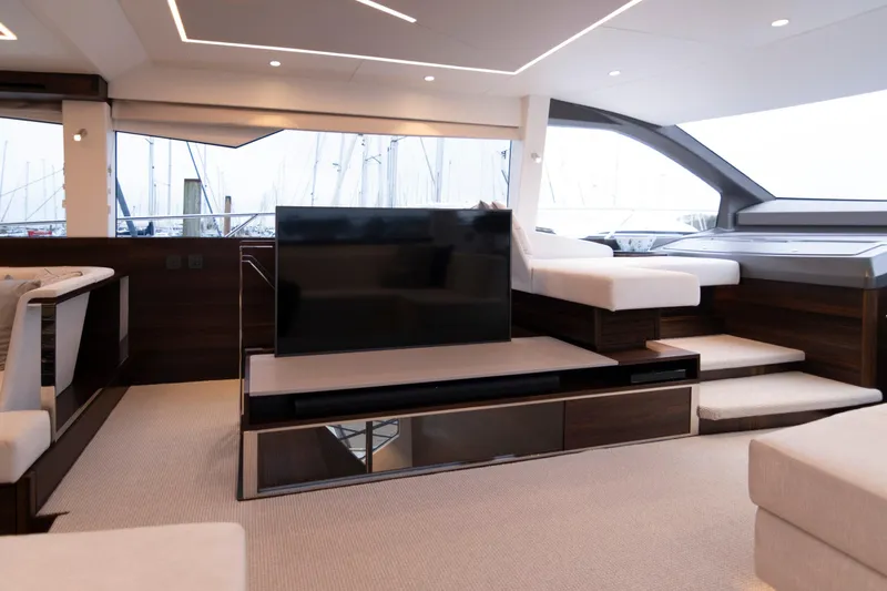 Baillies Yacht Photos Pics Luxurious interior of 2021 Sunseeker Manhattan 68 yacht with modern seating and TV.