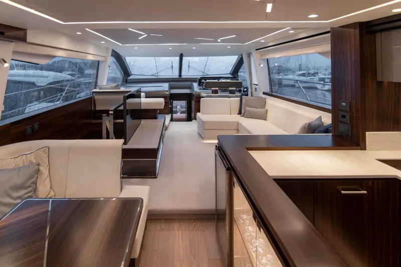 Baillies Yacht Photos Pics Luxurious interior of 2021 Sunseeker Manhattan 68 yacht with modern furnishings and panoramic windows.