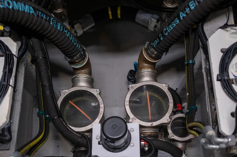 Baillies Yacht Photos Pics Engine room of 2021 Sunseeker Manhattan 68 yacht, featuring hoses and gauges.