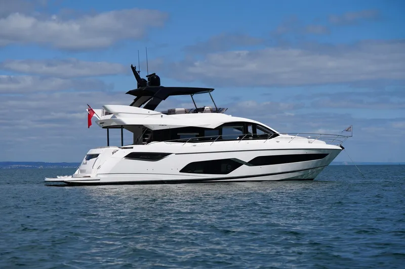 Baillies Yacht Photos Pics 2021 Sunseeker Manhattan 68 yacht on calm sea under blue sky.