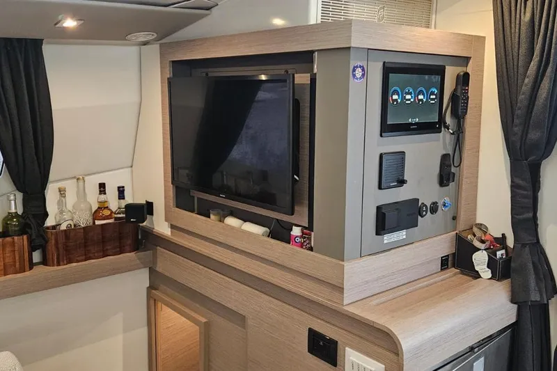 Talila Yacht Photos Pics Interior of 2022 Fountaine Pajot Tanna 47 yacht with control panel and bar area.