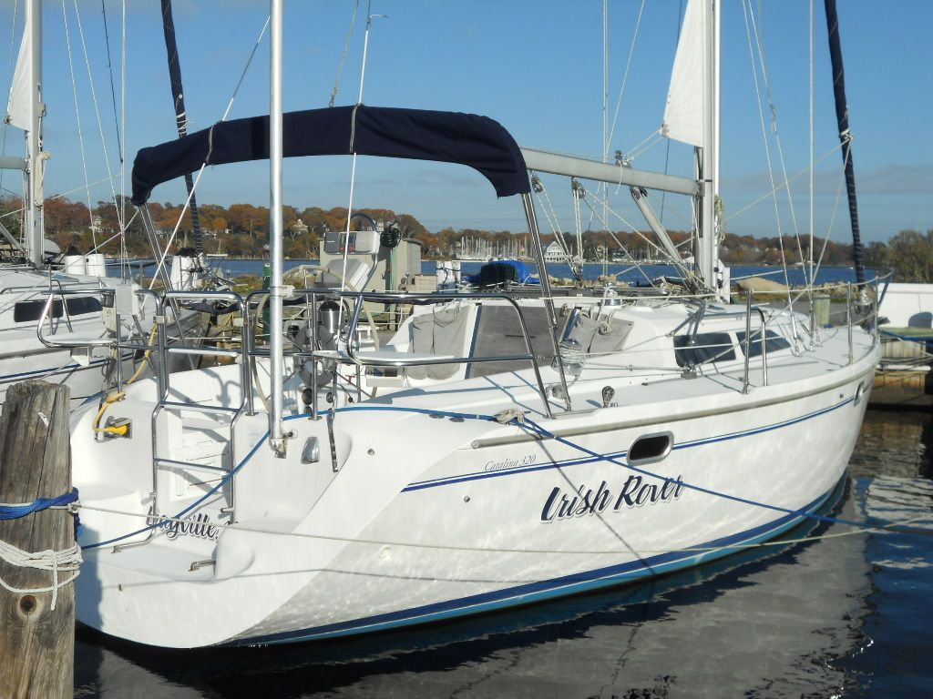 1999 Catalina 320 sailboat docked in harbor.