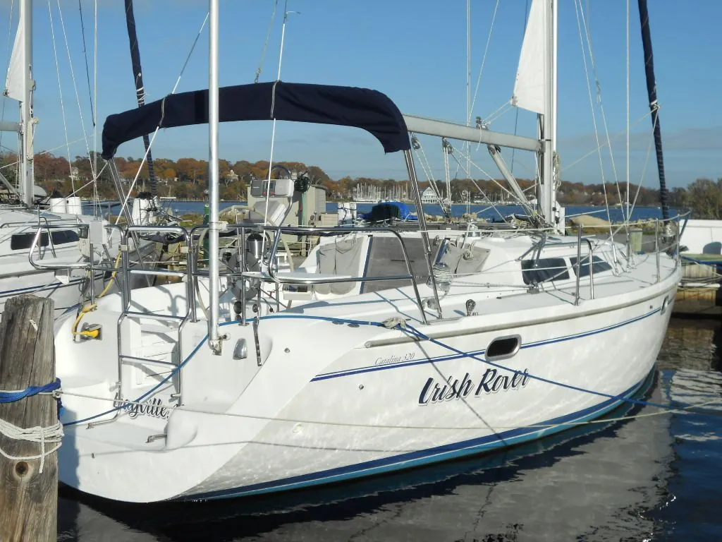 1999 Catalina 320 sailboat docked in harbor.