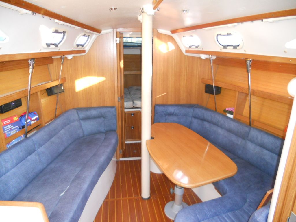 Interior of a 1999 Catalina 320 yacht with blue upholstery.