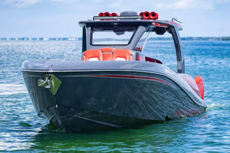  Yacht Photos Pics 2022 Deep Impact 399 Sport boat on clear blue water, featuring sleek design and vibrant seating.