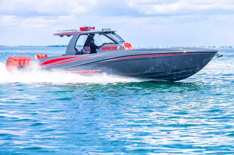  Yacht Photos Pics 2022 Deep Impact 399 Sport boat cruising on open water, showcasing sleek design and performance.
