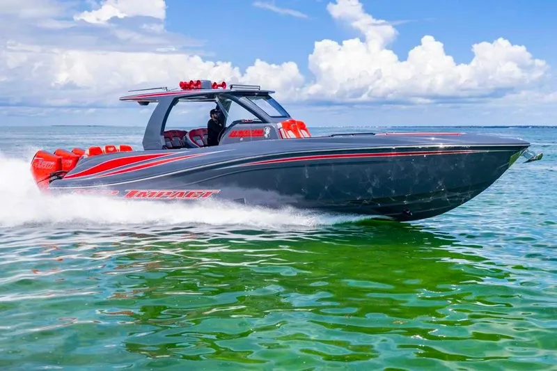  Yacht Photos Pics 2022 Deep Impact 399 Sport boat cruising on clear green water under a blue sky.