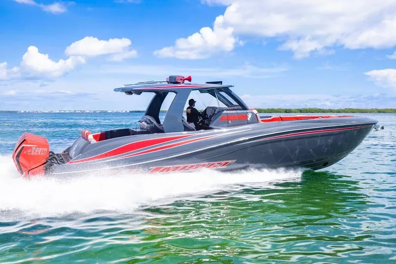  Yacht Photos Pics 2022 Deep Impact 399 Sport boat cruising on clear blue water under a sunny sky.