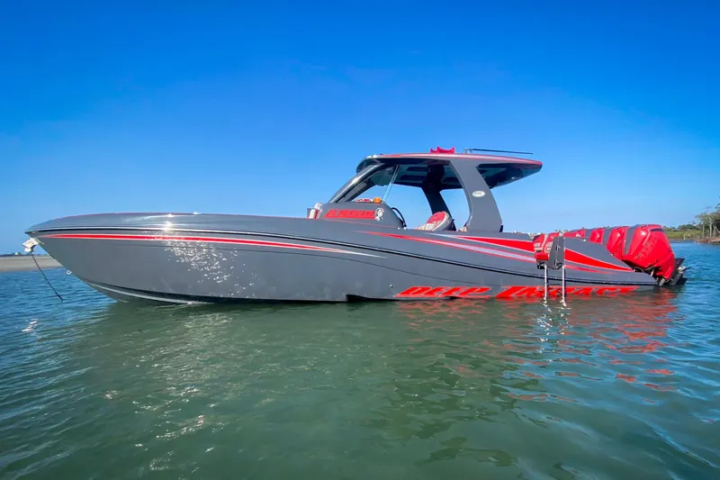  Yacht Photos Pics 2022 Deep Impact 399 Sport boat on water, sleek gray design with red accents.