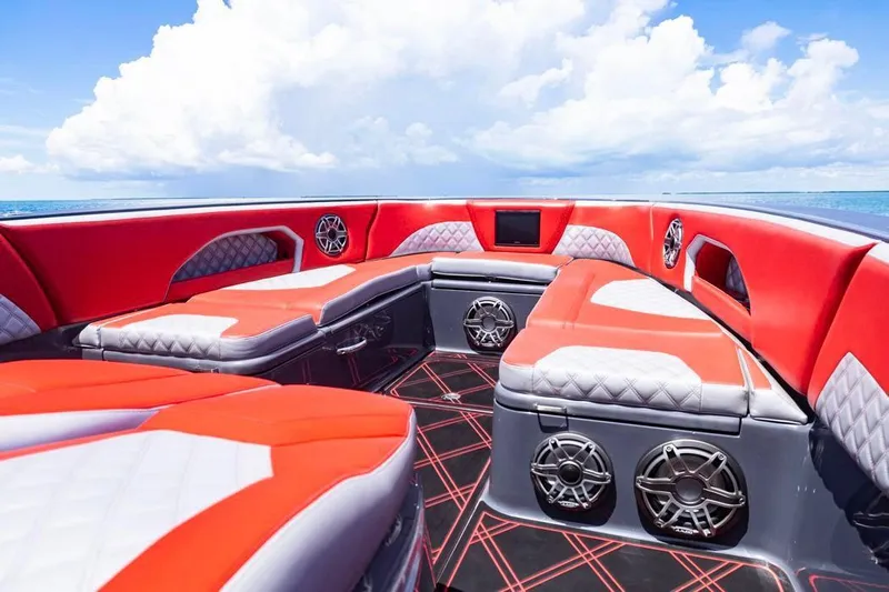 Yacht Photos Pics Luxurious interior of 2022 Deep Impact 399 Sport boat with red and gray seating.