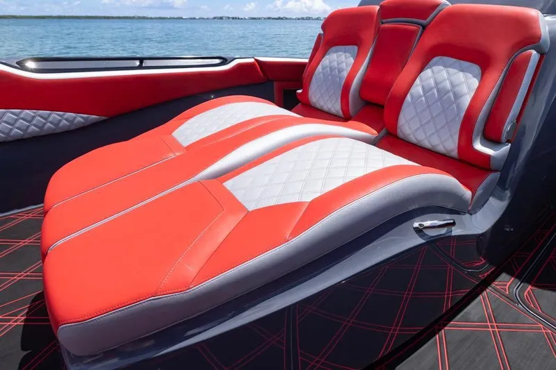  Yacht Photos Pics Luxurious red and white seating on 2022 Deep Impact 399 Sport boat, ocean backdrop.