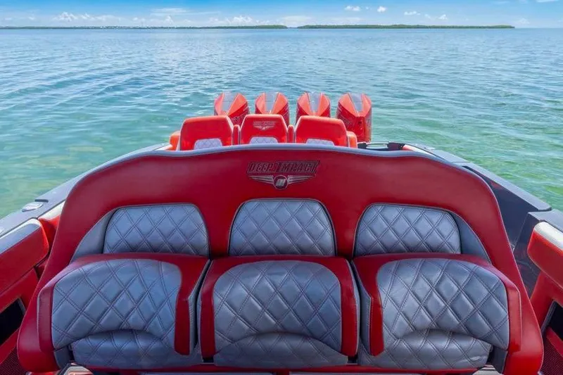 Yacht Photos Pics 2022 Deep Impact 399 Sport boat with red and gray seating on open water.