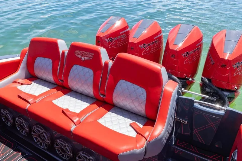 Yacht Photos Pics 2022 Deep Impact 399 Sport boat with red seating and four powerful outboard engines.