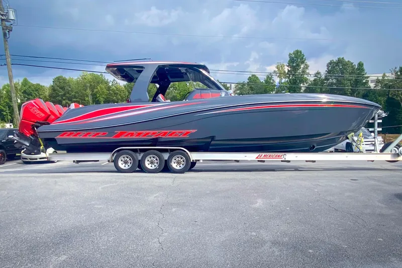  Yacht Photos Pics 2022 Deep Impact 399 Sport boat on trailer, featuring sleek design and vibrant red accents.
