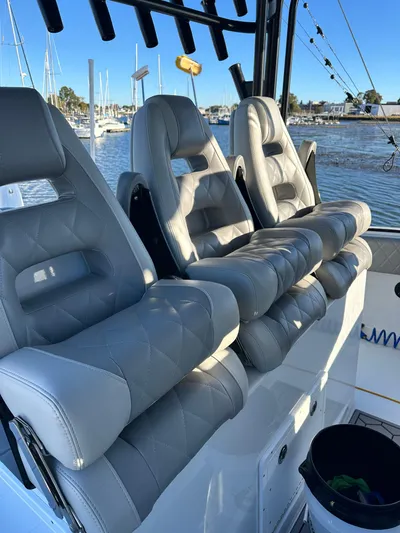  Yacht Photos Pics Luxurious seating on a 2024 Wyatt and Freeman 42LR boat, docked at a marina.