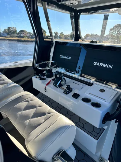  Yacht Photos Pics Luxurious 2024 Wyatt and Freeman 42LR boat interior with Garmin navigation displays.