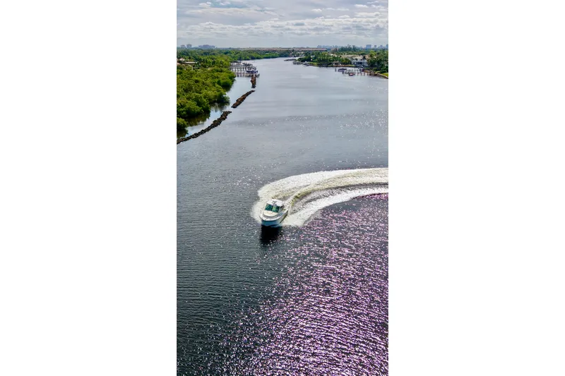 Mr Ceo Yacht Photos Pics Aerial view of 2015 Boston Whaler 315 Conquest cruising on a scenic river.