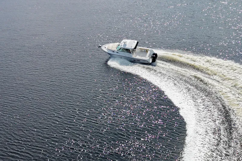 Mr Ceo Yacht Photos Pics Aerial view of 2015 Boston Whaler 315 Conquest making a sharp turn on water.
