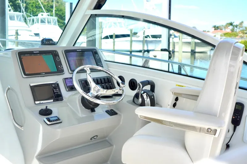 Mr Ceo Yacht Photos Pics 2015 Boston Whaler 315 Conquest helm with modern navigation equipment and comfortable seating.