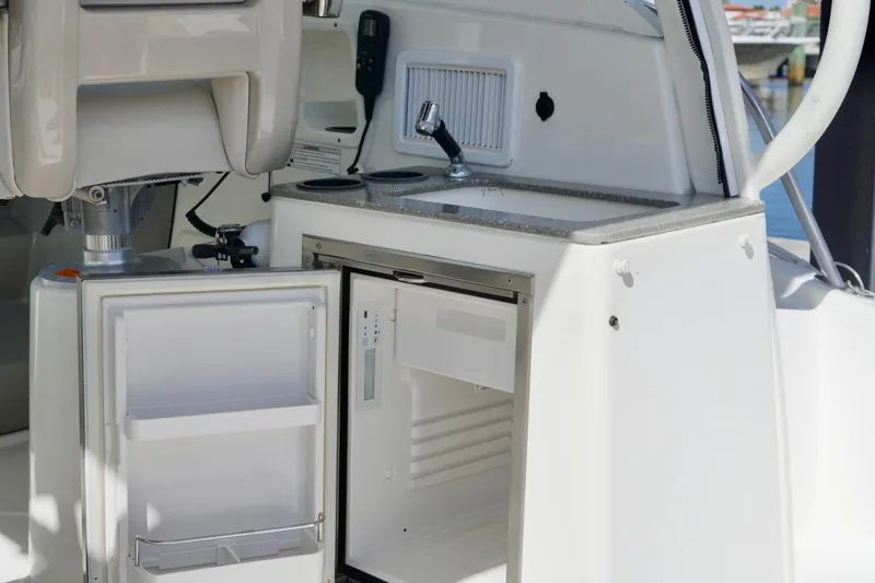 Mr Ceo Yacht Photos Pics 2015 Boston Whaler 315 Conquest boat interior with open fridge and sink.