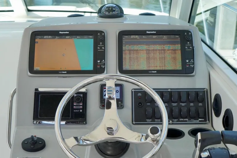 Mr Ceo Yacht Photos Pics 2015 Boston Whaler 315 Conquest helm with dual Raymarine displays and steering wheel.