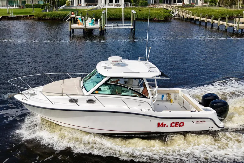 Mr Ceo Yacht Photos Pics 2015 Boston Whaler 315 Conquest boat cruising on a river.