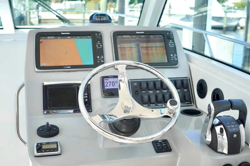 Mr Ceo Yacht Photos Pics Control panel of a 2015 Boston Whaler 315 Conquest boat with navigation screens.