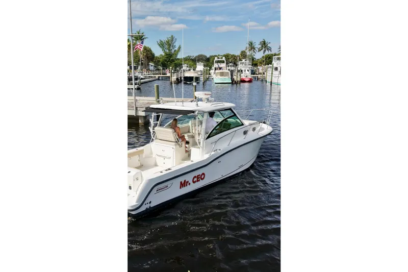 Mr Ceo Yacht Photos Pics 2015 Boston Whaler 315 Conquest boat named "Mr. CEO" docked in a marina.
