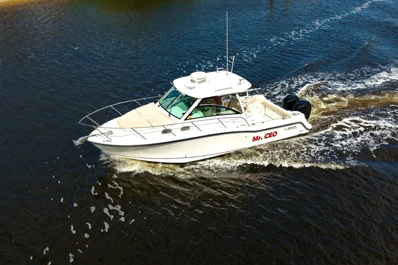 Mr Ceo Yacht Photos Pics 2015 Boston Whaler 315 Conquest boat cruising on water, labeled "Mr. CEO."