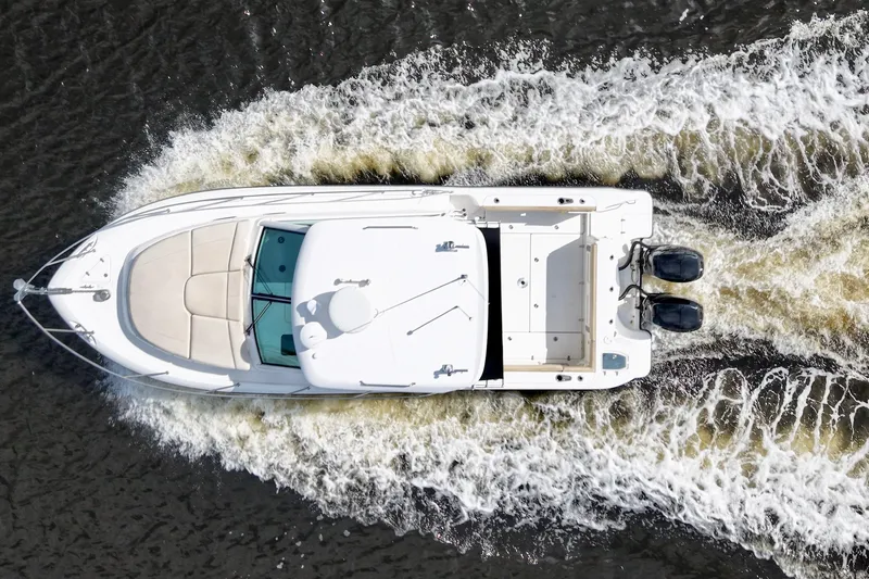 Mr Ceo Yacht Photos Pics Overhead view of 2015 Boston Whaler 315 Conquest boat cruising on water.