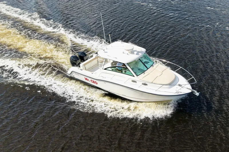 Mr Ceo Yacht Photos Pics 2015 Boston Whaler 315 Conquest cruising on water, aerial view.