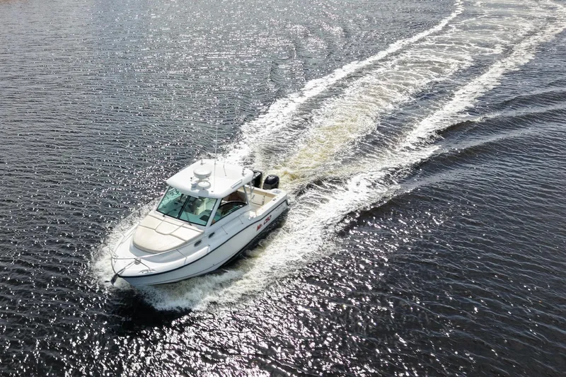 Mr Ceo Yacht Photos Pics 2015 Boston Whaler 315 Conquest cruising on open water, leaving a wake behind.