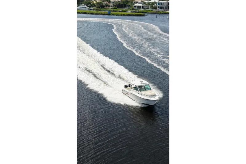 Mr Ceo Yacht Photos Pics 2015 Boston Whaler 315 Conquest cruising on a scenic waterway.
