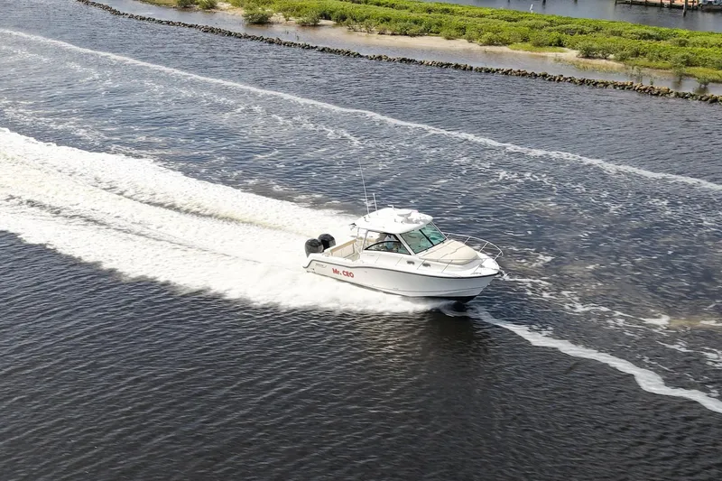 Mr Ceo Yacht Photos Pics 2015 Boston Whaler 315 Conquest cruising on a scenic waterway.