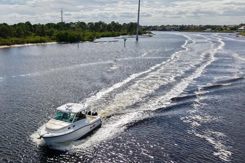 Mr Ceo Yacht Photos Pics 2015 Boston Whaler 315 Conquest cruising on a scenic waterway.