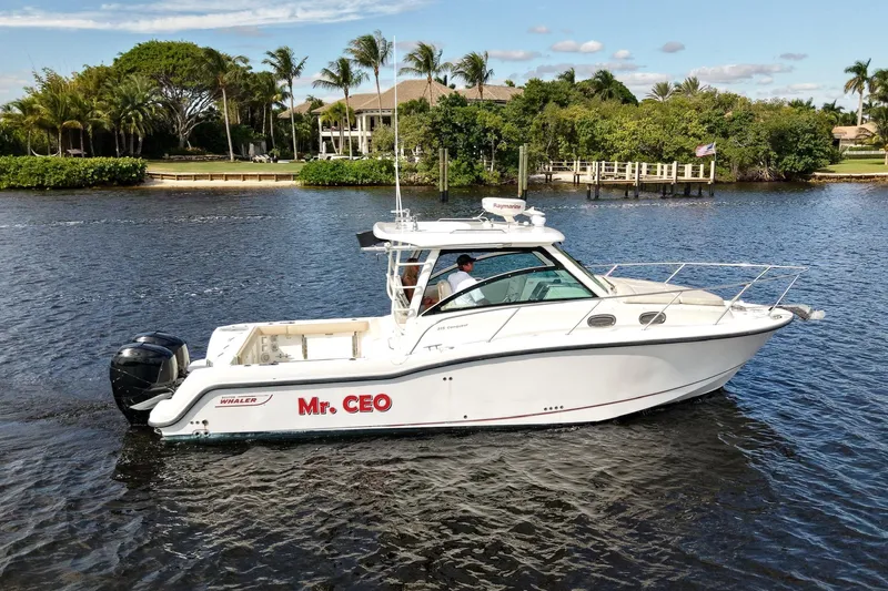 Mr Ceo Yacht Photos Pics 2015 Boston Whaler 315 Conquest boat named "Mr. CEO" cruising on a scenic waterway.